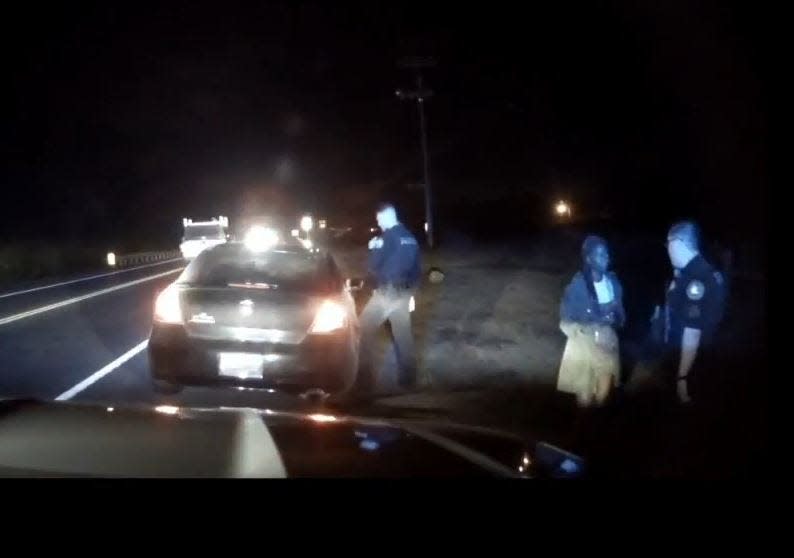 Police question a woman during a Nov. 2 traffic stop where Eric Allen was fatally shot.