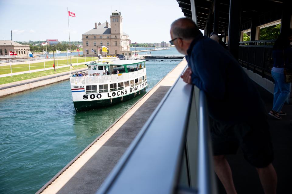 Visitors watch as the Soo Locks tour boats demonstrate how boats move through the system Wednesday, July 13, 2022, in downtown Sault Ste. Marie.