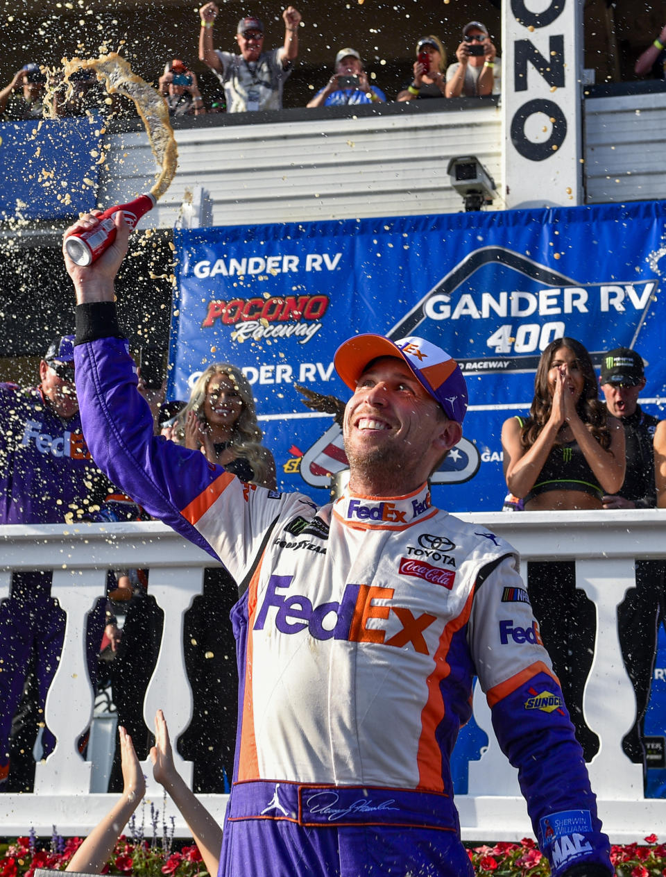 Denny Hamlin celebrates in Victory Lane after winning a NASCAR Cup Series auto race, Sunday, July 28, 2019, in Long Pond, Pa. (AP Photo/Derik Hamilton)