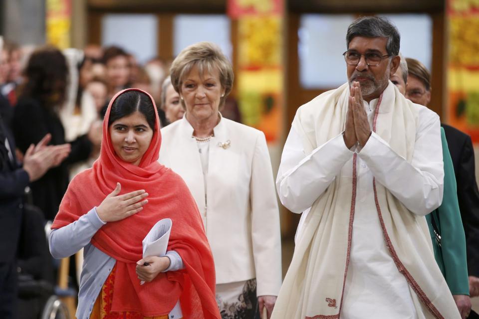 Nobel Peace Prize laureates Malala Yousafzai (L) and Kailash Satyarthi arrive for the Nobel Peace Prize awards ceremony at the City Hall in Oslo December 10, 2014. Pakistani teenager Malala Yousafzai, shot by the Taliban for refusing to quit school, and Indian activist Kailash Satyarthi received their Nobel Peace Prizes on Wednesday after two days of celebration honouring their work for children's rights. REUTERS/Cornelius Poppe/NTB Scanpix/Pool (NORWAY - Tags: SOCIETY) NORWAY OUT. NO COMMERCIAL OR EDITORIAL SALES IN NORWAY.