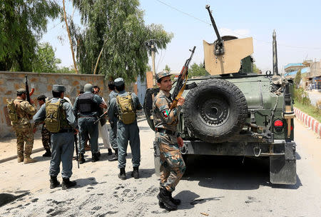 Afghan policemen leave the site of an attack in Jalalabad city, Afghanistan July 11, 2018. REUTERS/Parwiz