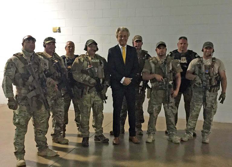 Dutch Member of Parliament Geert Wilders stands with members of a US SWAT team outside the venue where a Prophet Mohammed cartoon contest was being held in Garland, Texas, May 3, 2015