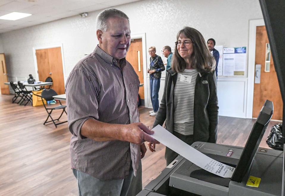 Jim Woody, left, votes near poll manager Debbie Hand during elections in Belton, S.C. Tuesday, November 7, 2023.