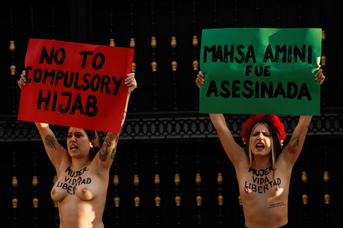 <p>SENSITIVE MATERIAL. THIS IMAGE MAY OFFEND OR DISTURB Activists from the women's rights group FEMEN hold signs, during a protest following the death of Mahsa Amini, outside the Embassy of Iran, in Madrid, Spain, September 23, 2022. REUTERS/Susana Vera</p> 