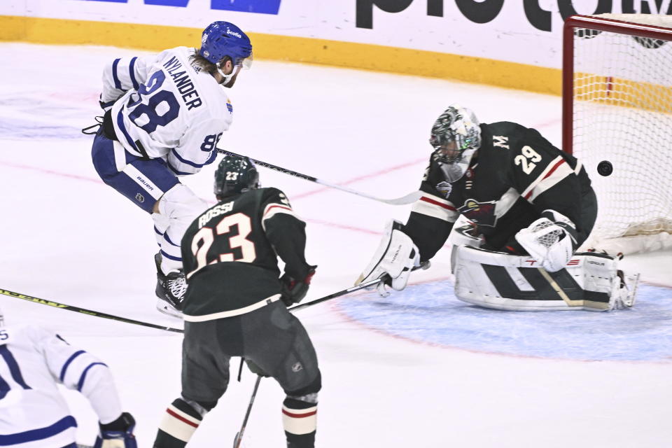 Toronto's William Nylander, top left, scores at Minnesota's goalkeeper Marc-Andre Fleury during the NHL Global Series Sweden ice hockey match between Toronto Maple Leafs and Minnesota Wild at Avicii Arena in Stockholm, Sweden, Sunday, Nov. 19, 2023. (Claudio Bresciani/TT via AP)