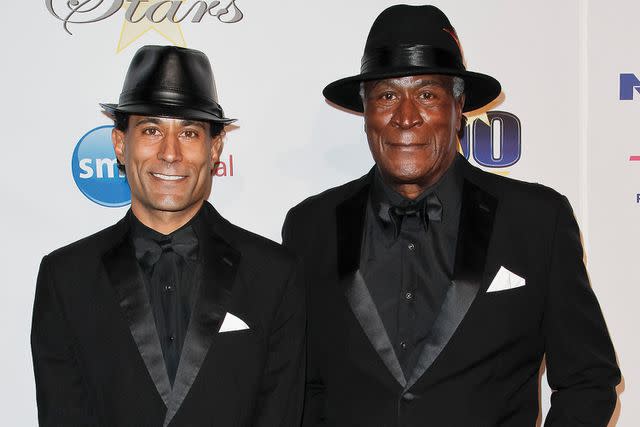 <p>Tibrina Hobson/WireImage</p> John Amos and his son K.C.