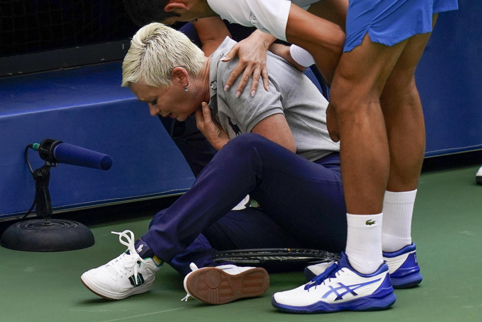 Novak Djokovic, of Serbia, checks a line judge after inadvertently hitting her with a ball in reaction to losing a point to Pablo Carreno Busta, of Spain, during the fourth round of the US Open tennis championships, Sunday, Sept. 6, 2020, in New York. Djokovic defaulted the match. (AP Photo/Seth Wenig)