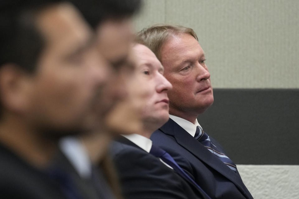 Jon Gruden, right, waits in court Wednesday, May 25, 2022, in Las Vegas. A Nevada judge heard a bid Wednesday by the National Football League to dismiss former Las Vegas Raiders coach Jon Gruden's lawsuit accusing the league of a "malicious and orchestrated campaign" including the leaking of offensive emails ahead of his resignation last October. (AP Photo/John Locher)