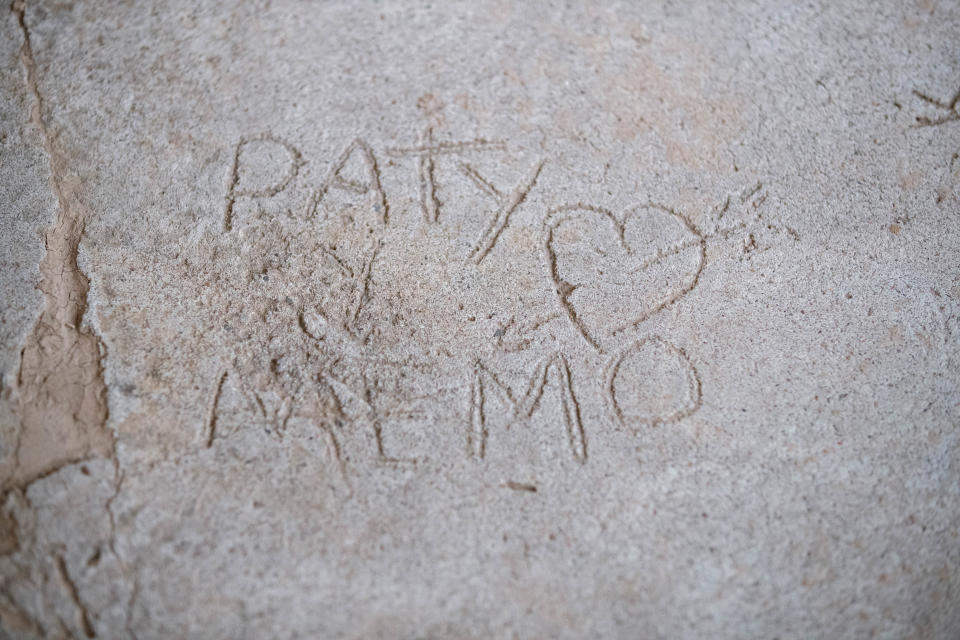 Names and handprints pressed in cement are some of what remains at Guillermo and Patricia Aguirre's Mendez Street home in La Union. The home was devastated by flooding in August 2021. Pictured Wednesday, Feb. 2, 2022.