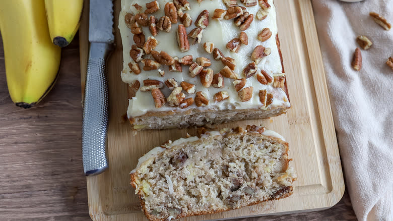 sliced frosted hummingbird bread on a cutting board