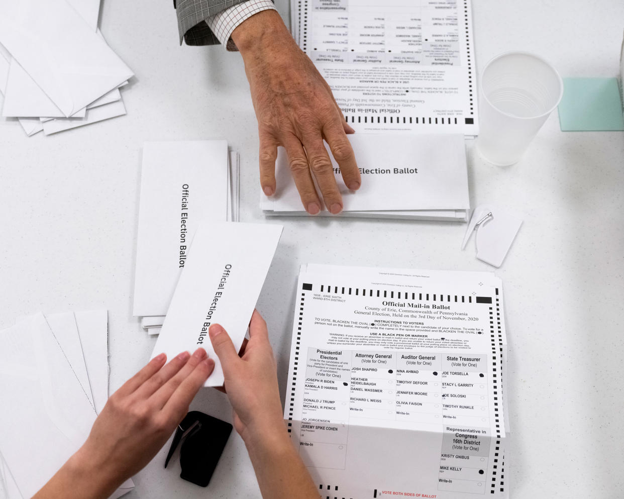 Mailed ballots being opened at an Erie County courthouse on Election Day, the earliest time Pennsylvania allows it