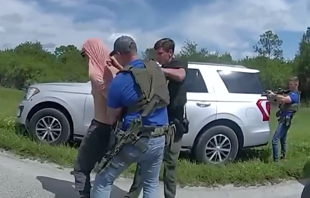 A screengrab shows law enforcement offiers taking Ryan Wesley Routh into custody.