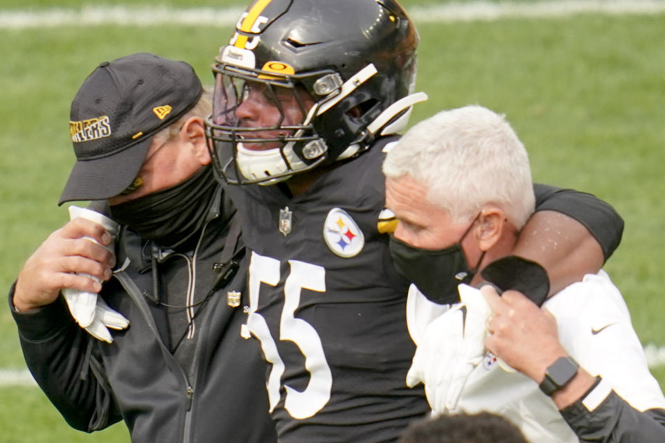 Pittsburgh Steelers inside linebacker Devin Bush (55) is helped from the field after he was injured in the first half of an NFL football game against the Cleveland Browns, Sunday, Oct. 18, 2020, in Pittsburgh. Steelers head coach Mike Tomlin said in the post game news conference that Bush suffered a significant injury to a knee on the play. (AP Photo/Gene J. Puskar)