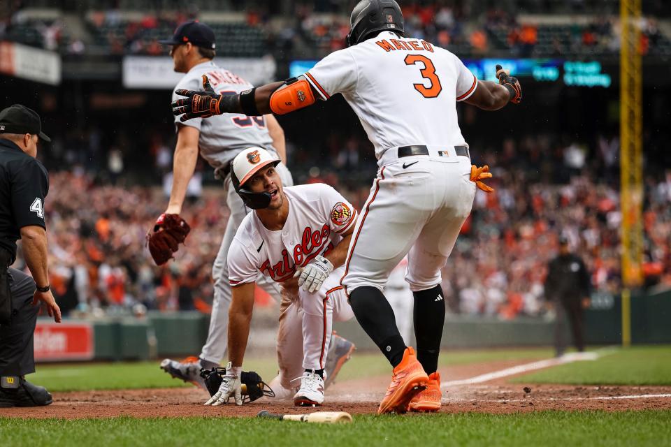 Baltimore Orioles second baseman Adam Frazier celebrates with shortstop Jorge Mateo after scoring the game winning run against the Detroit Tigers during the tenth inning at Oriole Park at Camden Yards on April 23, 2023