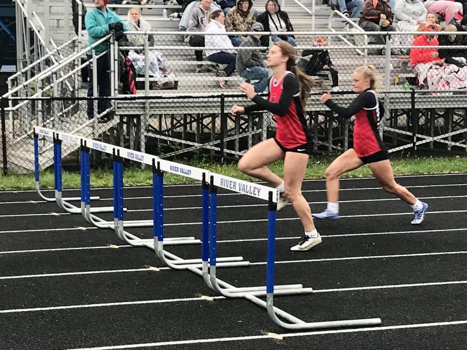 Pleasant's Tayden Obenour, left and Grace Cobb compete in the 100-meter hurdles at Wednesday's Marion County Track Meet at River Valley.