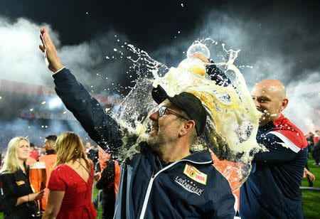 Soccer Football - Bundesliga Relegation Playoff - Union Berlin v VfB Stuttgart - Stadion An der Alten Forsterei, Berlin, Germany - May 27, 2019 Union Berlin coach Urs Fischer has beer poured over him as they celebrate winning the match REUTERS/Annegret Hilse DFL regulations prohibit any use of photographs as image sequences and/or quasi-video