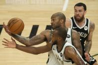 Milwaukee Bucks' P.J. Tucker and Khris Middleton steal the ball from Brooklyn Nets' Mike James during the first half of Game 4 of the NBA Eastern Conference basketball semifinals game Sunday, June 13, 2021, in Milwaukee. (AP Photo/Morry Gash)