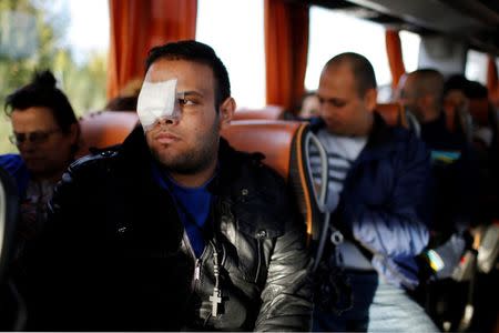 Christian Syrian refugee Walid Aleid, injured in a September bomb attack in Damascus, rides in a bus from Paris to Le Mans with fifteen family members who arrived at the Charles-de-Gaulle Airport in Roissy from Beirut, October 2, 2015. REUTERS/Stephane Mahe