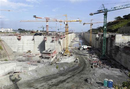 Workers and cranes are seen at the construction site of the Panama Canal Expansion project on the Atlantic side on the outskirts of Colon City January 15, 2014. REUTERS/Carlos Jasso