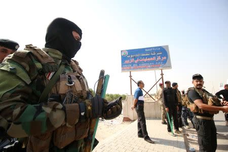 Iraqi security forces are seen during a protest at the main entrance to the giant Zubair oilfield near Basra, Iraq July 17, 2018. REUTERS/Essam al-Sudani