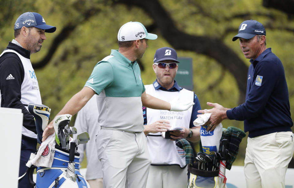 Sergio Garcia, second from left and Matt Kuchar, right, discuss on the eighth hole what had happened on the seventh green, during the Dell Technologies Match Play Championship golf tournament, Saturday, March 30, 2019, in Austin, Texas. Garcia had an 8-foot putt to win the seventh hole and left it 4 inches short, a frustrating miss. Worse yet was what followed. Such a tap-in typically is conceded in the Dell Technologies Match Play, and the Spaniard walked up and casually rapped it left-handed. The ball spun around the cup, and he picked it up and walked off the green, assuming he remained 1 down through seven holes. One problem: Matt Kuchar never formally conceded the putt. (AP Photo/Eric Gay)