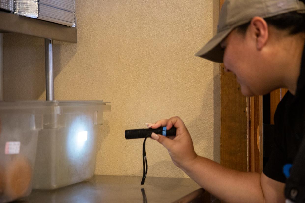 Joanie Garza, a public health inspector with the city, checks the dates and labeling on storage containers during a restaurant inspection on June, 6 2023, in Corpus Christi, Texas.