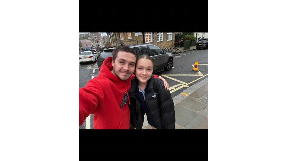 Brooklyn and harper beckham selfie on street