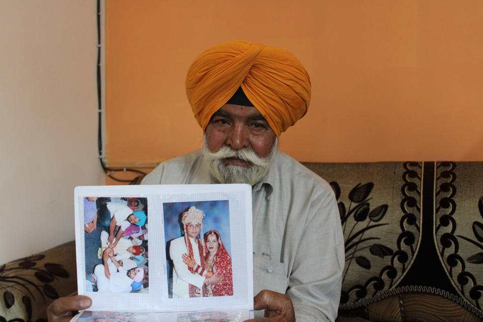 Jit Singh showing his daughter Jagdeep Kaur’s wedding album at his home in Akalgarh, Ludhiana, on April 9.<span class="copyright">Bilal Kuchay</span>