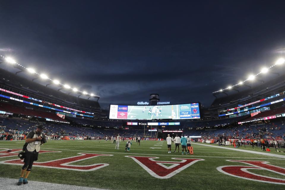 FILE — Lights illuminate Gillette Stadium before an NFL football game between the New England Patriots and the Miami Dolphins, Sunday, Sept. 17, 2023, in Foxborough, Mass. One of two Rhode Island men charged with assault and battery and disorderly conduct in connection with the death of a fan at a New England Patriots game pleaded not guilty Friday, Jan. 19, 2024. (AP Photo/Michael Dwyer, File)