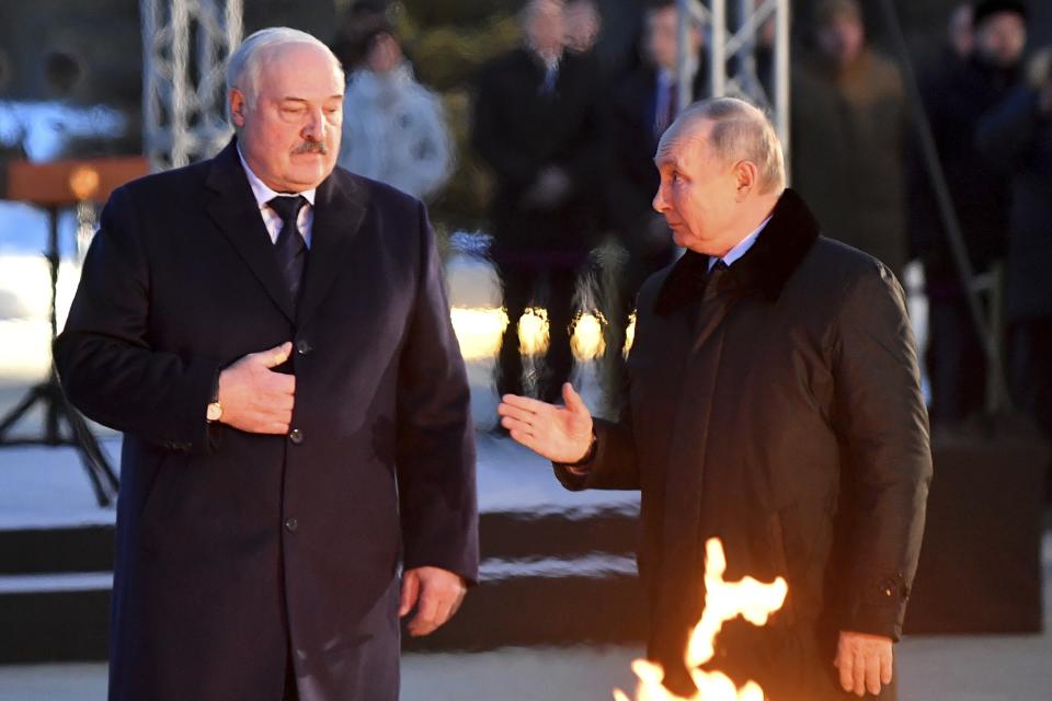 Russian President Vladimir Putin, right, and Belarusian President Alexander Lukashenko speak to each other while attending the opening ceremony of the memorial complex "To the peaceful citizens of the Soviet Union who died during the Great Patriotic War", WWII, near Zaitsevo village in the Leningrad Region, Russia, Saturday, Jan. 27, 2024. The ceremony marked the 80th anniversary of the battle that lifted the Siege of Leningrad. The Nazi siege of Leningrad, now named St. Petersburg, was fully lifted by the Red Army on Jan. 27, 1944. More than 1 million people died mainly from starvation during the nearly 900-day siege. (Olga Maltseva/Pool Photo via AP)