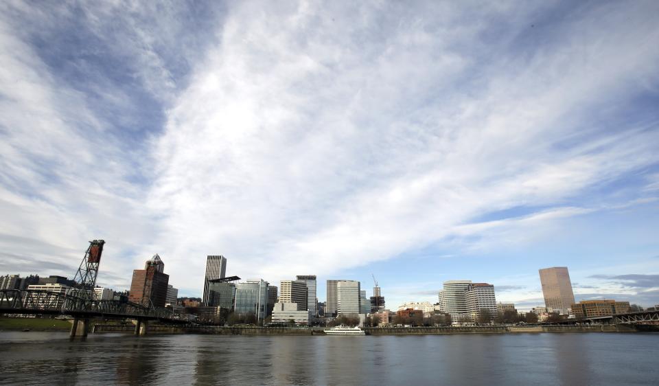 FILE - In this Dec. 13, 2014, file photo the Portland skyline is visible on the west bank of the Willamette River in Portland, Ore. On Friday, July 7, 2023, The Associated Press reported on stories circulating online incorrectly claiming Oregon has more registered voters than state residents. (AP Photo/Don Ryan, File)