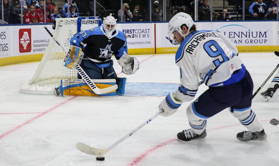 All-Stars forward Olivier Archambault (9) looks to score on Jacksonville Icemen goaltender Stephen Mundinger (33) during Monday night's 2022 ECHL All-Star Classic.