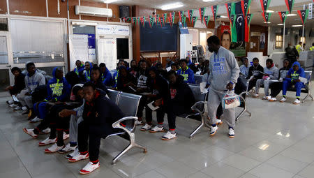 Guinean migrants wait at the airport before they are deported to Guinea, in Misrata, Libya, December 27, 2017. REUTERS/Ismail Zitouny