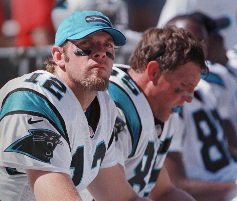 Carolina quarterback Kerry Collins and tight end Wesley Walls sit on the bench during the Panthers' 37-30 loss to the Green Bay Packers.