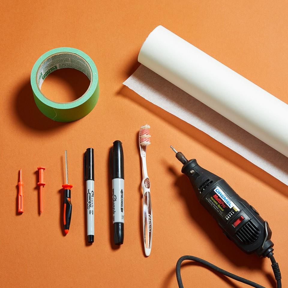 pumpkin carving materials lying on an orange background