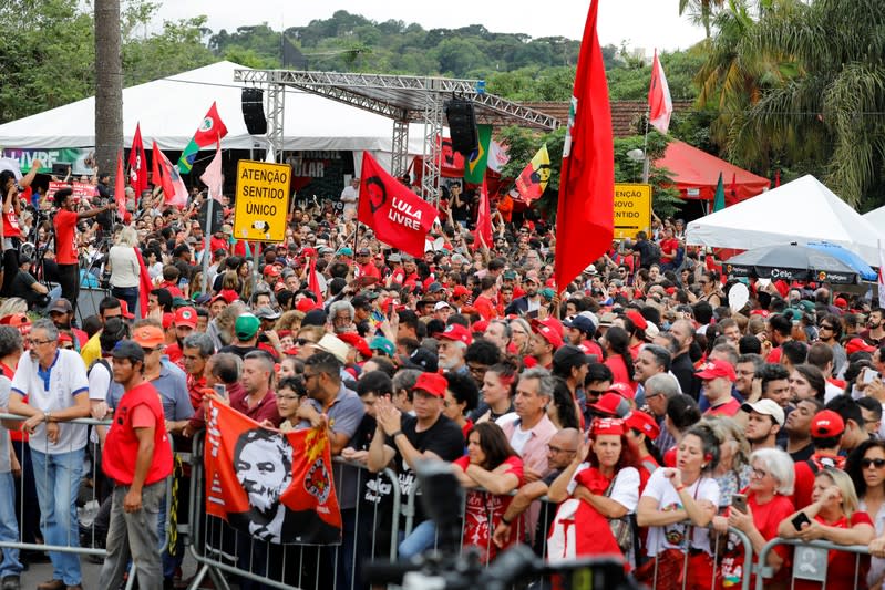 Supporters of Brazil's former President Luiz Inacio Lula da Silva wait outside the Federal Police headquarters where Lula is serving a prison sentence, in Curitiba