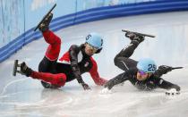 Canada's Charles Hamelin (L) and Eduardo Alvarez of the U.S. fall during the men's 1,000 metres short track speed skating quarter-finals race at the Iceberg Skating Palace at the Sochi 2014 Winter Olympics February 15, 2014. REUTERS/Lucy Nicholson (RUSSIA - Tags: SPORT SPEED SKATING OLYMPICS TPX IMAGES OF THE DAY) ATTENTION EDITORS: PICTURE 09 OF 20 FOR PACKAGE 'SOCHI - EDITOR'S CHOICE' TO FIND ALL SEARCH 'EDITOR'S CHOICE - 15 FEBRUARY 2014'