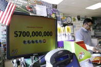 <p>A Powerball lottery sign displays the lottery prizes at a convenience store, Aug. 23, 2017, in Northbrook, Ill. Lottery officials said the grand prize for Wednesday night’s drawing has reached $700 million, the second -largest on record for any U.S. lottery game. (Photo: Nam Y. Huh/AP) </p>