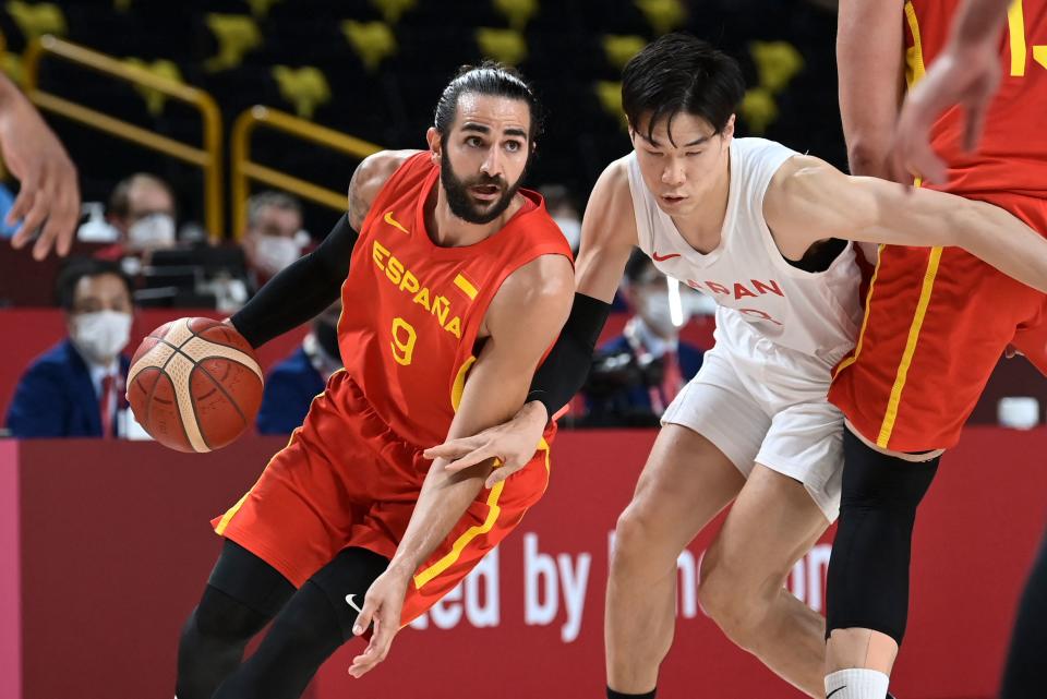 Spain's Ricky Rubio dribbles the ball past Japan's Yudai Baba in the men's preliminary round group C basketball match between Japan and Spain during the Tokyo 2020 Olympic Games at the Saitama Super Arena in Saitama on July 26, 2021. (Photo by Aris MESSINIS / AFP) (Photo by ARIS MESSINIS/AFP via Getty Images)