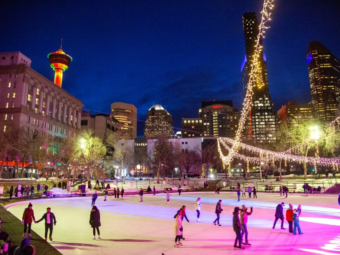 Skaters take a spin around the illuminated Olympic Plaza rink during the Chinook Blast festival in downtown Calgary. A drag event at the plaza was cancelled due to anticipated protests this weekend. (Colleen De Neve for CBC News - image credit)