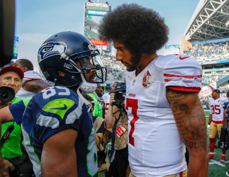 Colin Kaepernick, speaking with Seattle's Doug Baldwin in 2016, has filed a grievance against the NFL for allegedly blackballing him from the league. (Getty Images) 