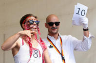 BERLIN, GERMANY - JULY 21: A contestant receives a judge's verdict in the make-your-own-ironic-Hipster-moustache competition at the second annual Hipster Olympics on July 21, 2012 in Berlin, Germany. With events such as the "Horn-Rimmed Glasses Throw," "Skinny Jeans Tug-O-War," "Vinyl Record Spinning Contest" and "Cloth Tote Sack Race," the Hipster Olympics both mocks and celebrates the Hipster subculture, which some critics claim could never be accurately defined and others that it never existed in the first place. The imprecise nature of determining what makes one a member means that the symptomatic elements of adherants to the group vary in each country, but the archetype of the version in Berlin, one of the more popular locations for those following its lifestyle, along with London and Brooklyn, includes a penchant for canvas tote bags, the carbonated yerba mate drink Club Mate, analogue film cameras, asymetrical haircuts, 80s neon fashion, and, allegedly, a heavy dose of irony. To some in Berlin, members of the hipster "movement" have replaced a former unwanted identity in gentrifying neighborhoods, the Yuppie, for targets of criticism, as landlords raise rents in the areas to which they relocate, particularly the up-and-coming neighborhood of Neukoelln. (Photo by Adam Berry/Getty Images)