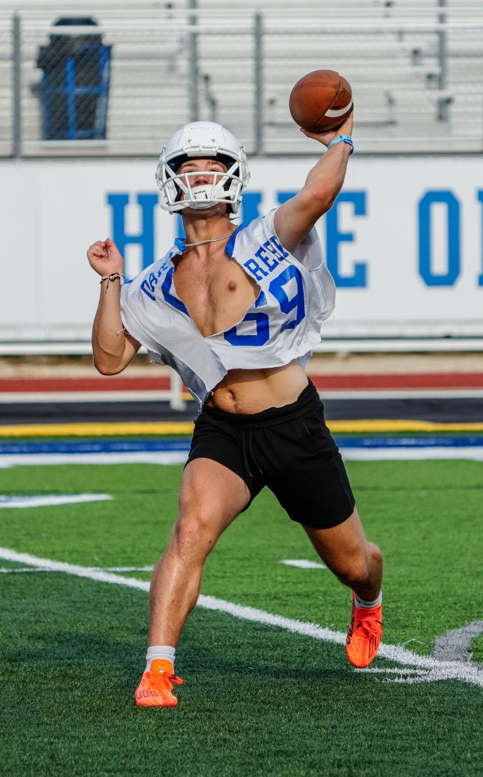 Oak Creek quarterback Cade Palkowski delivers a pass during high school football practice on Wednesday, August 2, 2023.