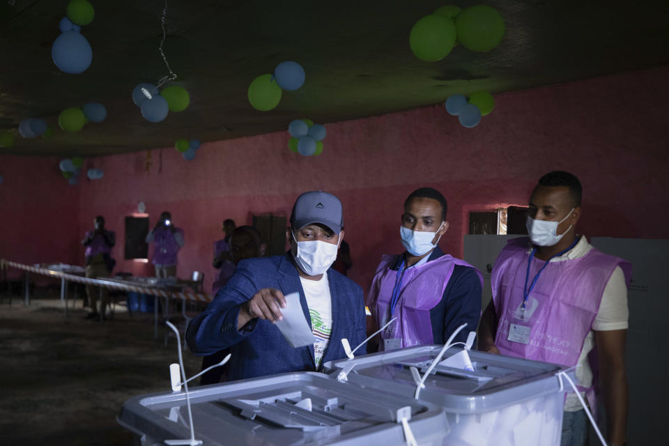 FILE - In this Monday, June 21, 2021 file photo, Ethiopia's Prime Minister Abiy Ahmed, center, casts his vote in the general election, in his home town of Beshasha, in the Oromia region of Ethiopia. Ethiopia's ruling Prosperity Party was declared on Saturday, July 10, 2021 the winner of last month's national election in a landslide, assuring a second term for Prime Minister Abiy Ahmed. (AP Photo/Mulugeta Ayene, File)