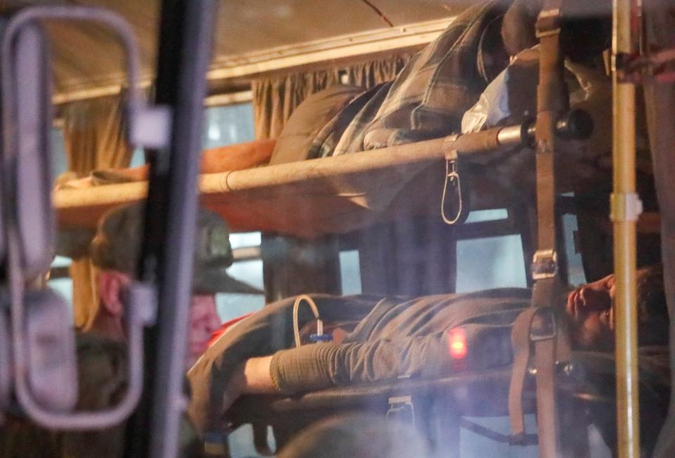 Wounded service members of Ukrainian forces from the besieged Azovstal steel mill in Mariupol lie on stretchers in a bus, which arrived under escort of the pro-Russian military in the course of Ukraine-Russia conflict in Novoazovsk, Ukraine 16 May 2022 (Reuters)