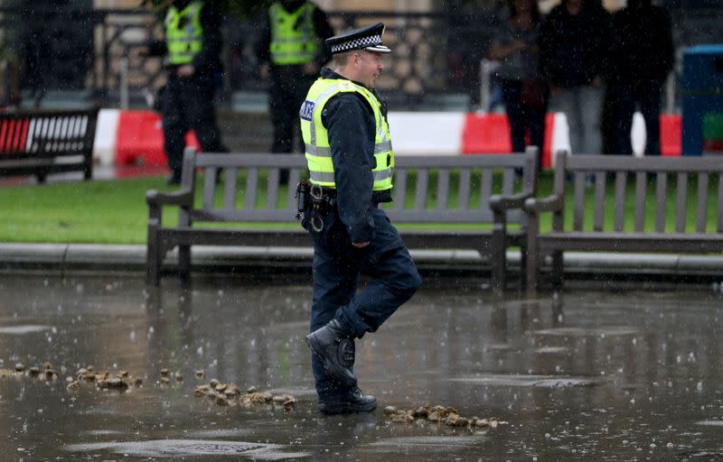 A police officer walks at George Square in Glasgow