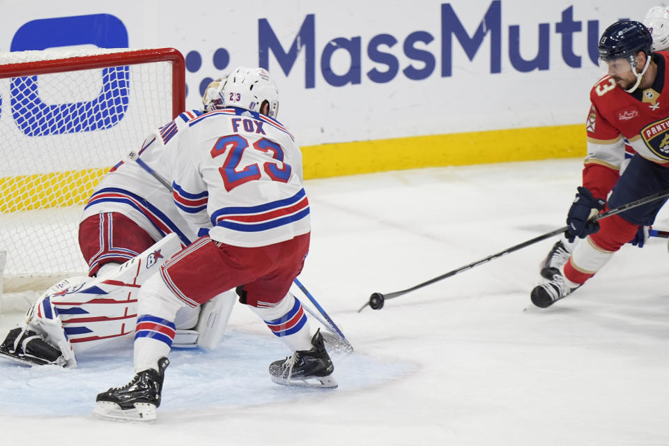 Florida Panthers center Sam Reinhart, far right, scores against New York Rangers defenseman Adam Fox (23) and goaltender Igor Shesterkin, rear, in the first period of Game 3 during the Eastern Conference finals of the NHL hockey Stanley Cup playoffs, Sunday, May 26, 2024, in Sunrise, Fla. (AP Photo/Wilfredo Lee)