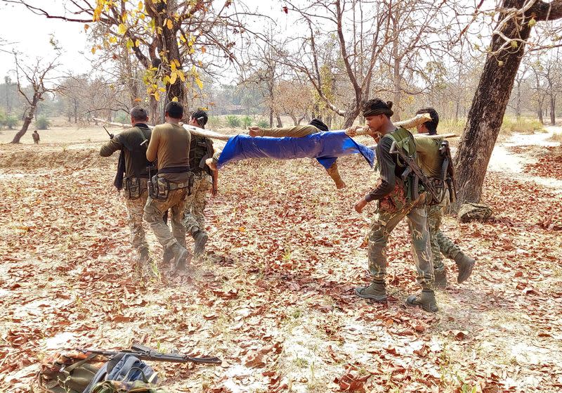 Security force personnel carry the body of their colleague after an attack by Maoist fighters in Bijapur