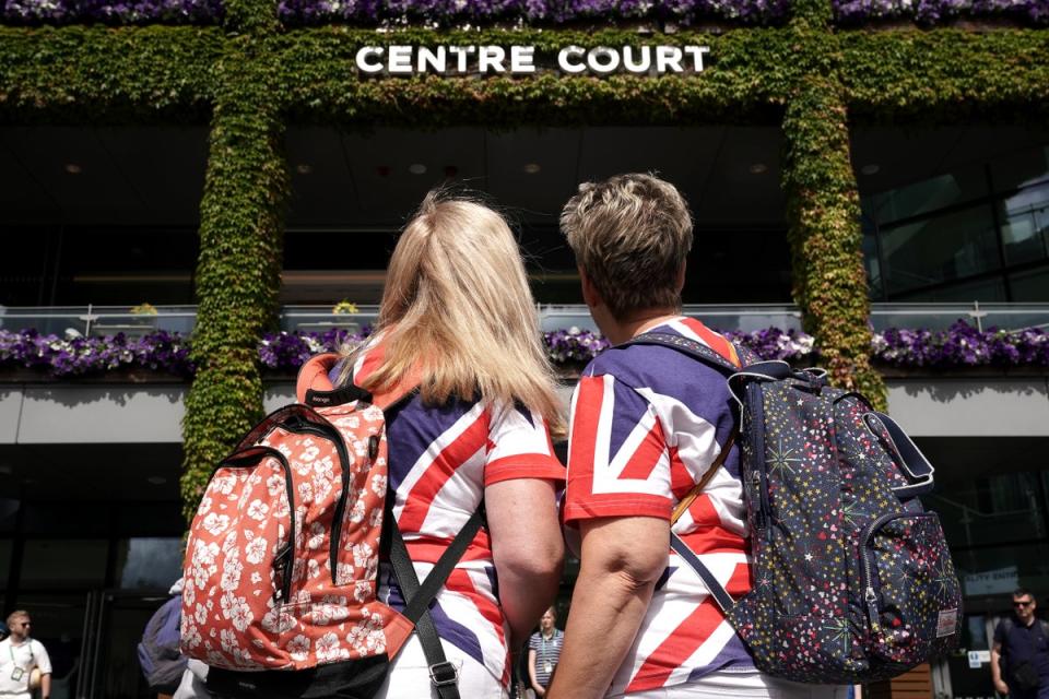 Spectators wearing Union Jack style T-shirts look towards Centre Court ahead of day one of the 2022 Wimbledon Championships (Aaron Chown/PA) (PA Wire)