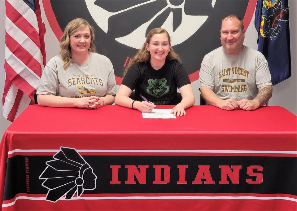 Flanked by parents Melissa Fisher and Dann McDermott, Conemaugh Township senior Brook McDermott announces her intentions to swim at St. Vincent College, May 23, in Davidsville.